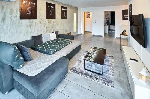 a living room with a couch and a tv at Wohlfühlnest in Sankt Leon-Rot