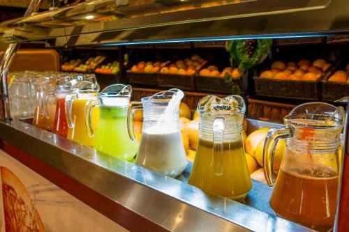 a bunch of different types of bottles of juice at Phoenicia Grand Hotel in Bucharest