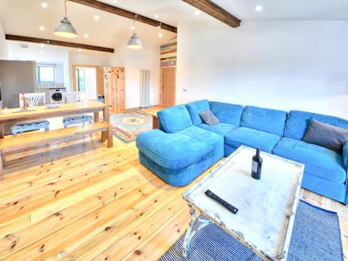 a living room with a blue couch and a table at Rondo - Ukc3211 in Newbridge