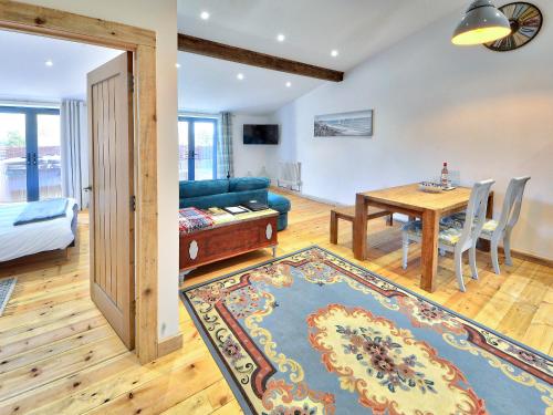 a living room with a table and a blue couch at Rondo - Ukc3211 in Newbridge