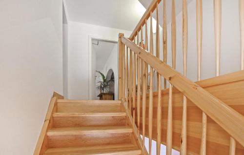 a wooden staircase in a home with white walls at Ferienwohnung Ankershagen in Friedrichsfeld