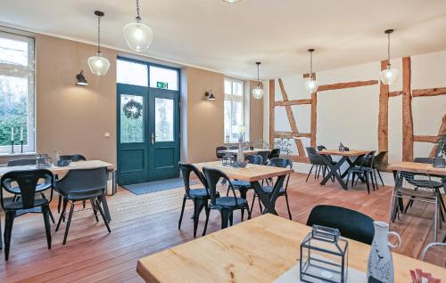 a restaurant with tables and chairs and a green door at Ferienwohnung Ankershagen in Friedrichsfeld