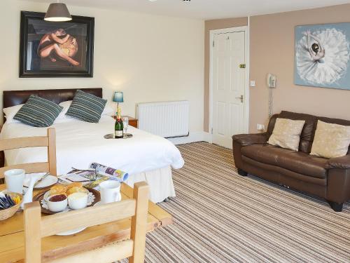 a living room with a bed and a couch at Lee Studio - Ukc3372 in West Down