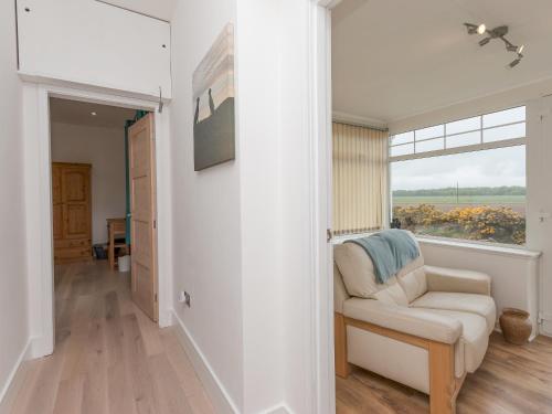 a living room with a chair and a window at Inverspey in Kingston