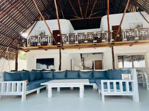 a living room with a blue couch and a table at Jumeirah Malindi Hotel in Malindi