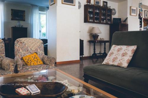 a living room with a couch and a table at Park Hotel Salice Terme - OltrePò Pavese - in Salice Terme