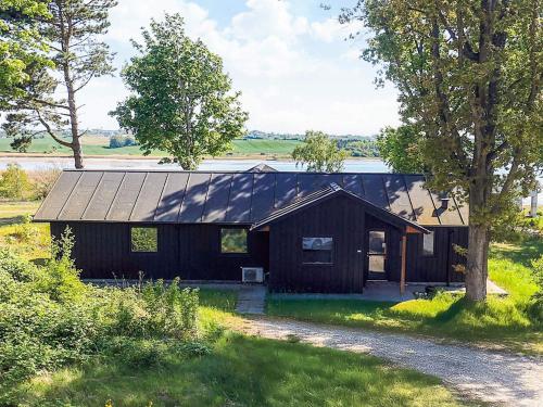 a house with a gambrel roof on top of it at 12 person holiday home in Millinge in Millinge