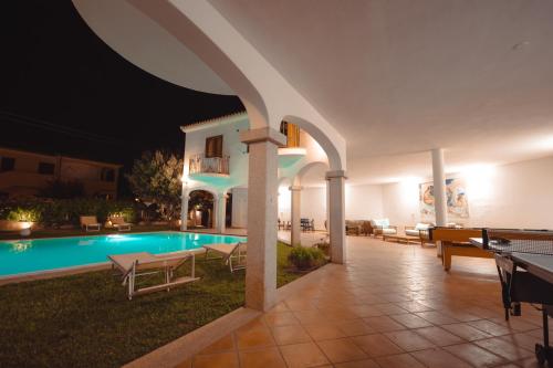 a villa with a swimming pool at night at Mera House in Posada