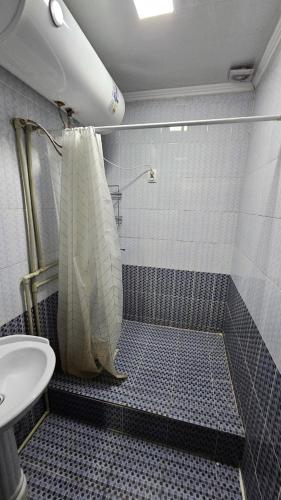 a bathroom with a shower with a toilet and a sink at Нур-Ордо in Pokrovka