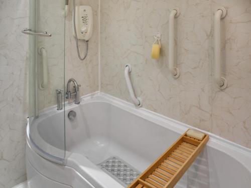 a bath tub in a bathroom with a phone at Swallowdale in Flordon