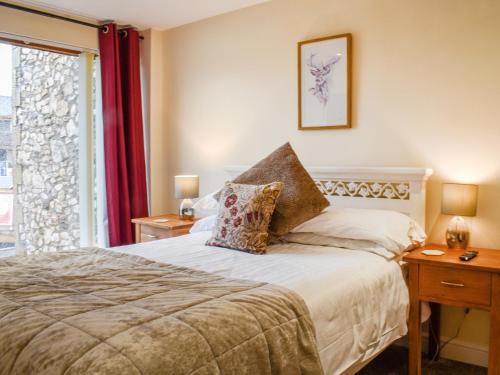 a bedroom with a bed and a window at Swan House in Carnforth