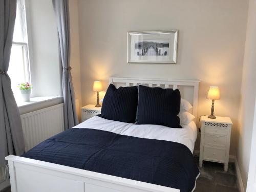 a bedroom with a large bed with two night stands at Hazelrigg in Bowness-on-Windermere