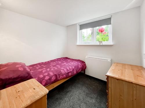 a small bedroom with a bed and a window at Triss - Uk47642 in Fontmell Magna