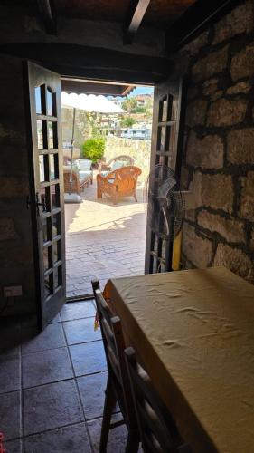a room with a table and an open door at Kalimera A Lovely 1-bedroom rental with ensuite and Kitchen in Limassol