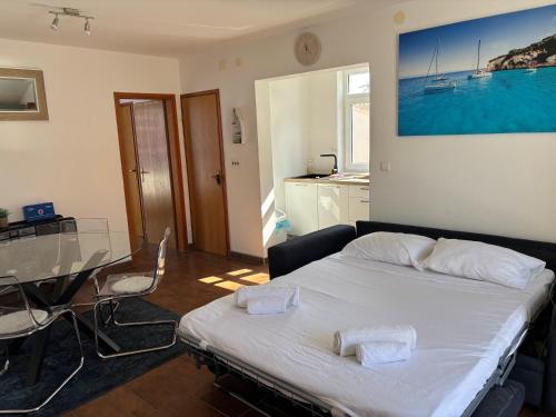 a bedroom with a bed and a glass table at Ocean Pearl in Vodice