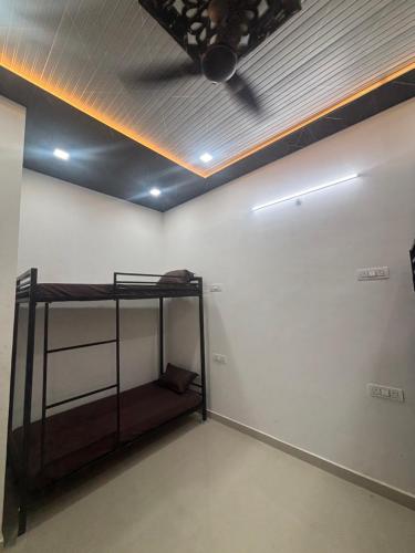 a room with a bunk bed and a ceiling at Rukmani Home Stay in Mathura