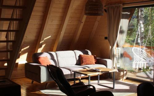 a living room with a couch and a table at Molika Forest House in Kolašin