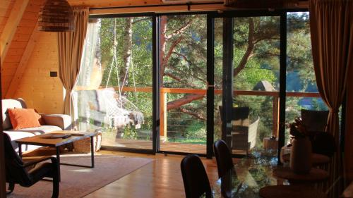 a living room with a large sliding glass door at Molika Forest House in Kolašin