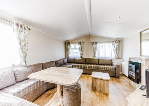 a living room with a couch and a table at Riverside Holiday Village in Uphill