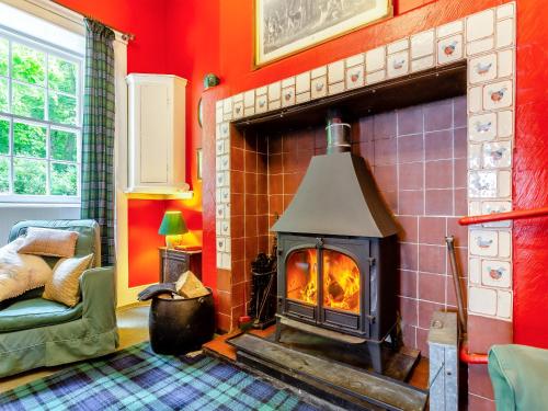 a living room with a brick fireplace in a room at The Ivy Wing in Slickly