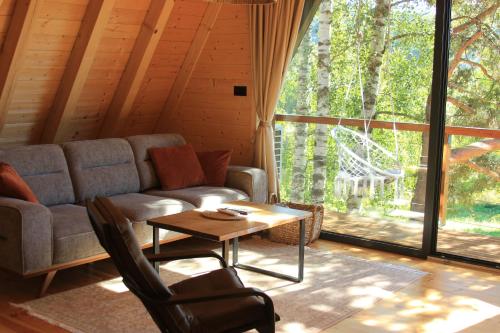 a living room with a couch and a table at Molika Forest House in Kolašin