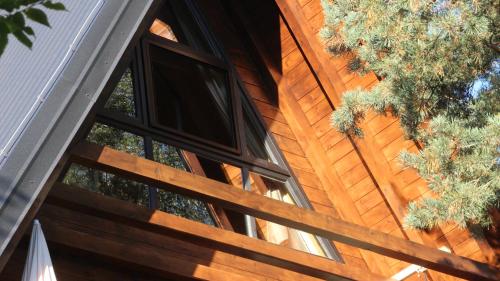 a group of windows on the side of a wooden building at Molika Forest House in Kolašin