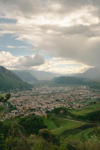 a view of a town in a valley with mountains at Hotel Post Gries in Bolzano