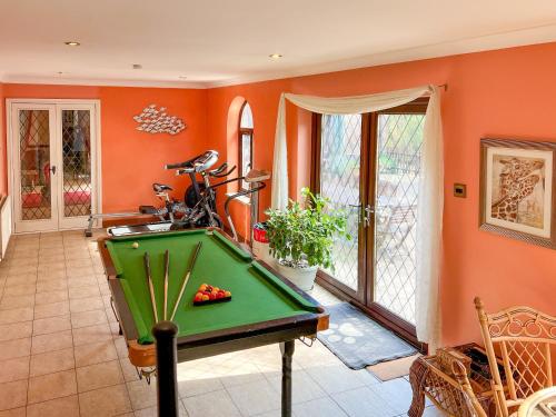 a pool table in a room with orange walls at Lambourne House - Ukc2831 in Winthorpe