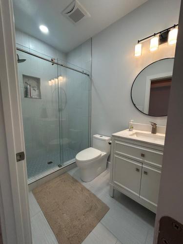 a bathroom with a shower and a toilet and a sink at Entire Guest Suite w Elevator - private and Independant in Dunn Loring
