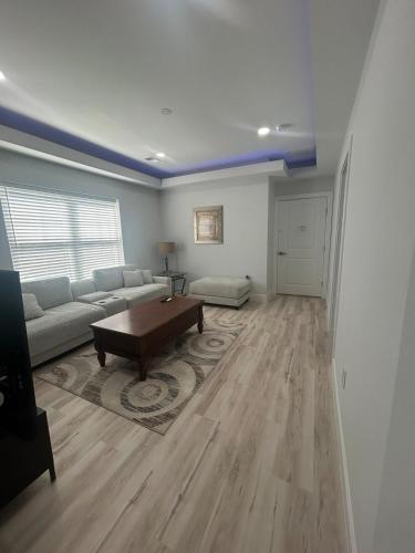 a living room with a couch and a coffee table at Entire Guest Suite w Elevator - private and Independant in Dunn Loring