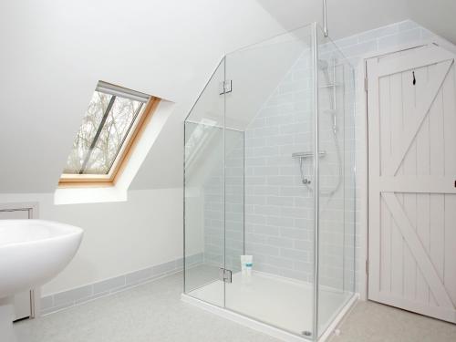 a bathroom with a glass shower stall and a sink at Little Robins in Trotterscliffe