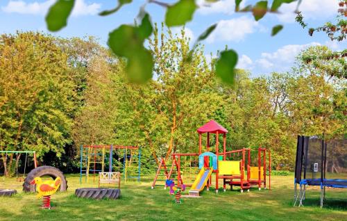 a playground with colorful play equipment in a park at Ferienhaus Verchen in Verchen