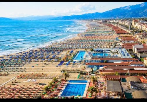 an aerial view of a beach with umbrellas and the ocean at Prestige Apartments in Viareggio