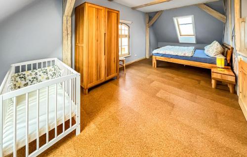 a room with two beds and a crib in it at Ferienhaus Hohen Demzin in Hohen Demzin