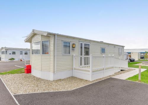 a tiny house is parked in a parking lot at Riverside Holiday Village in Uphill