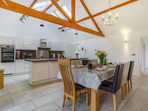 a kitchen and dining room with a table and chairs at Barrow Barn in Wicken