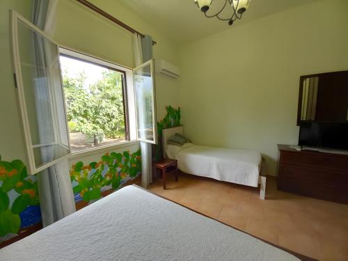 a bedroom with a bed and a window at Bnb I Gelsomini Selinunte in Marinella di Selinunte