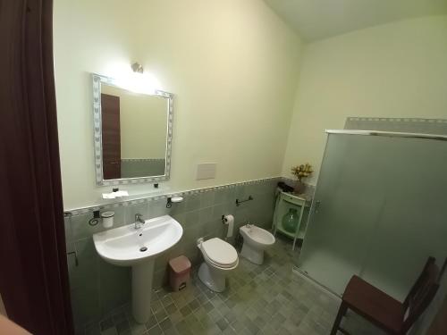 a bathroom with a sink and a toilet and a mirror at Bnb I Gelsomini Selinunte in Marinella di Selinunte