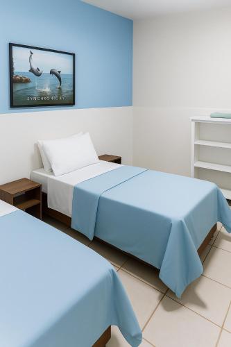 a bedroom with a bed and a tv on the wall at Pousada do Parque in Porto Alegre