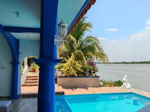 a view from the porch of a house overlooking the water at Hotel River Blue in Tlacotalpan
