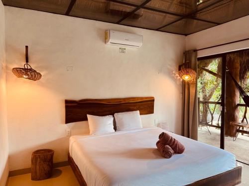 a bedroom with a bed in a room at Amarbacalar in Bacalar