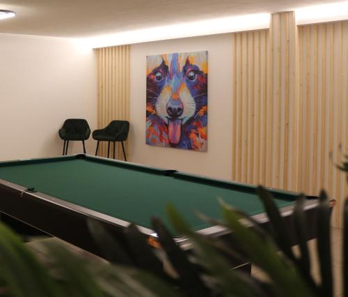 a pool table in a room with a painting at New Opening Penthouse Zirm in Selva dei Molini