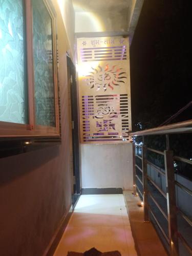 a hallway with a window and a sign on the wall at Hotel siddhi vinayak omkareshwar in Godarpura