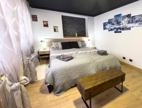 a bedroom with a large bed and a table at Casita con encanto, les gaites in Collanzo