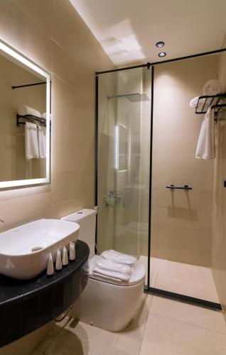 a bathroom with a shower and a sink and a toilet at Elevana Boutique hotel in Cairo