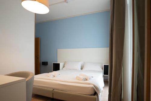 a bedroom with a bed with two towels on it at Hotel Minerva in Caorle