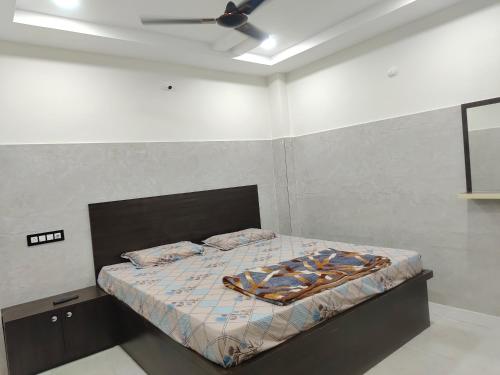 a bedroom with a bed with a ceiling fan at SWASTIK STAY Ac and Non Ac Rooms in Raigīr