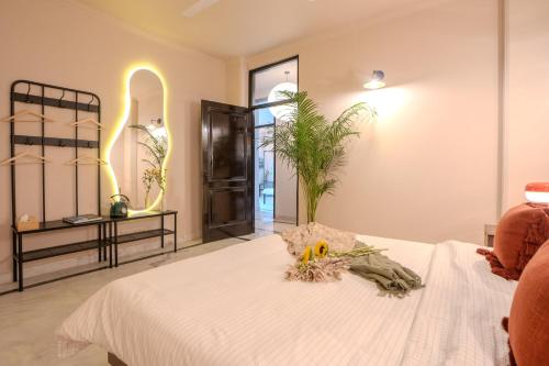 a bedroom with a white bed with flowers on it at 3000Sqft Ultra Luxury Apartment with Private Cinema In Delhi Poshest Locality Greater Kailash 2 in Jāmb
