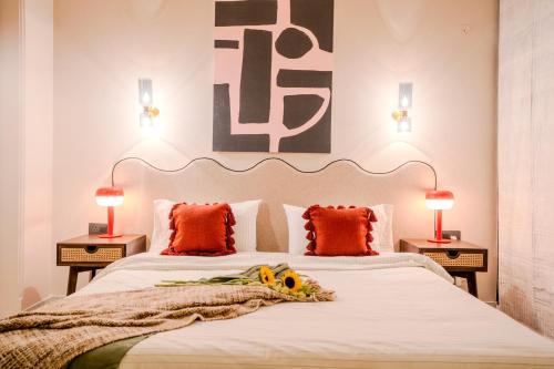 a bedroom with two beds with orange pillows and two lamps at 3000Sqft Ultra Luxury Apartment with Private Cinema In Delhi Poshest Locality Greater Kailash 2 in Jāmb
