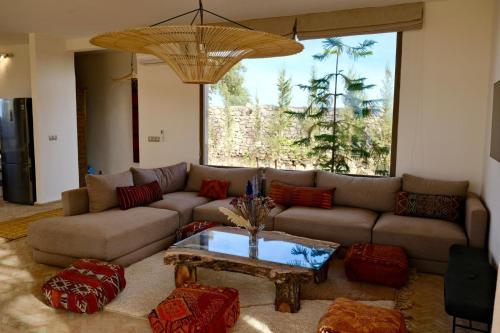 a living room with a couch and a table at Charming Beldi villa with pool in Sidi Kaouki
